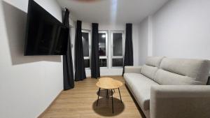 a living room with a couch and a table at C&C Suite in San Ciprián