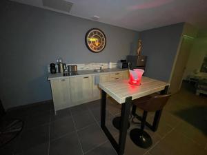 a kitchen with a table with a red candle on it at Le pont des rêves in Pont-sur-Sambre
