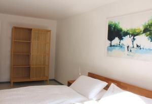 a bedroom with a bed and a painting on the wall at Casa Gialla in Russo