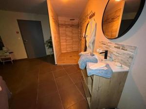 a bathroom with a sink and a mirror at Le pont des rêves in Pont-sur-Sambre