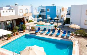 a pool at a hotel with chairs and umbrellas at Gennadi Gardens Apartments & Villas in Gennadi