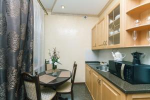 a small kitchen with a table and a microwave at Central Apartments in Kyiv