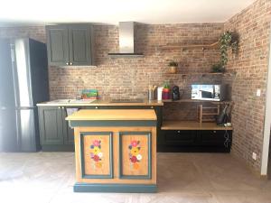 a kitchen with a kitchen island with a painting on it at Loft dans les vignes in La Cadière-dʼAzur