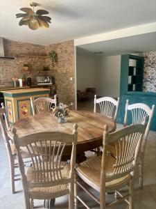 a dining room with a wooden table and chairs at Loft dans les vignes in La Cadière-dʼAzur