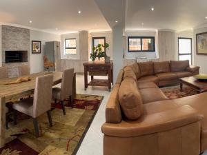 a living room with a couch and a table at Comfort Cove in Pretoria