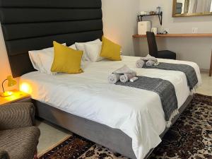 a bed with two stuffed animals on top of it at Comfort Cove in Pretoria