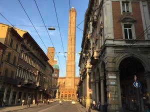 a building with a tall tower in the middle of a street at R&B Santo Stefano in Bologna