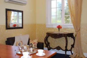 a dining room with a table and a mirror at Hall on the Terrace in Temuka