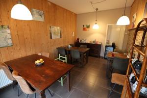 a dining room with wooden walls and tables and chairs at B&B Des4seigneurs in Gedinne