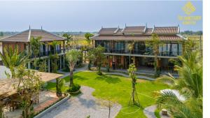 an aerial view of a house with palm trees at Sanctuary Homestay Battambang in Phumĭ Don Téav