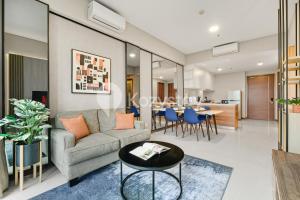 a living room with a couch and a table at Velir by Kozystay - BSD in Cilenggang