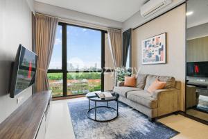 a living room with a couch and a large window at Velir by Kozystay - BSD in Cilenggang