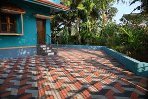 a house with a tile floor in front of a house at Ramleela Stay, Gokarna in Ankola