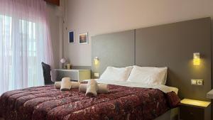 a hotel room with a bed with towels on it at rodou 39 apartment in Alexandroupoli