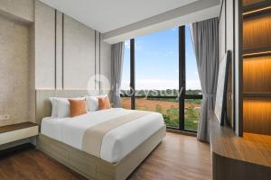 a bedroom with a large bed and a large window at Velir by Kozystay - BSD in Cilenggang +29 photos