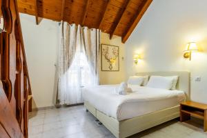 a bedroom with a bed and a large window at Jacob Ha-Tzayadim in Geʼullim +25 photos