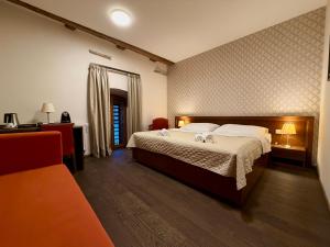 a bedroom with a large bed and a table and chairs at Hotel Chateau Orlice in Letohrad