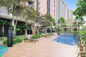 a courtyard with a swimming pool in a building at Velir by Kozystay - BSD in Cilenggang