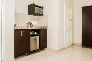 a kitchen with a sink and a counter top at Bayside Hotel Pietermaritzburg in Pietermaritzburg
