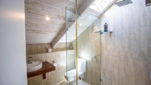 a bathroom with a toilet and a sink and a shower at Griki in Paternoster +21 photos