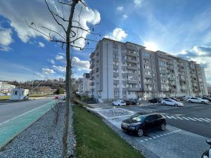 a black car parked in front of a building at Sunny View 2BR Apartment with Terrace - near VIVO and Amethyst in Floreşti