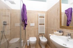 a bathroom with a toilet and a sink and a shower at Casamia Tuscan Oasis 4Br Panoramic Penthouse Hot Tub & Easy Parking in Siena +32 photos