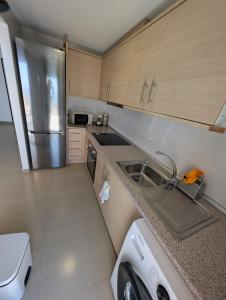 a kitchen with a sink and a stainless steel refrigerator at Hamaca & Sea in Cartagena
