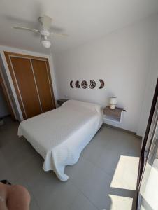 a bedroom with a bed and a ceiling fan at Hamaca & Sea in Cartagena