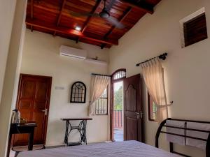 a bedroom with a bed and a wooden ceiling at Chill Tangalle in Tangalle +36 photos