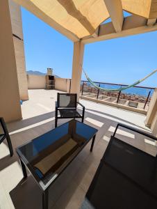 a room with two chairs and a table on a roof at Hamaca & Sea in Cartagena