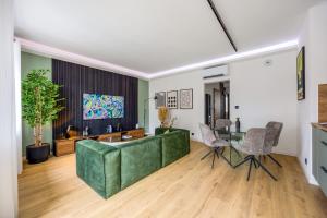 a living room with a green couch and a table at Slate at Max, Luxury in Mulhouse, Air Conditionné in Mulhouse