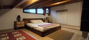a bedroom with a bed and a window in it at The Zephyr House -2- in Pyrgos