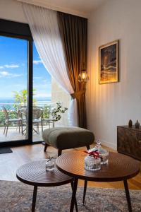 a living room with a bed and a table at Olive apartments in Petrovac na Moru