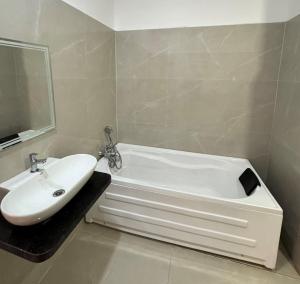 a bathroom with a white tub and a sink at Hotel M Plaza New Digha in Digha +38 photos