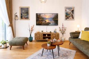 a living room with a couch and a table at Olive apartments in Petrovac na Moru