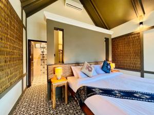 a bedroom with two beds in a room at KuangSi Resort in Luang Prabang