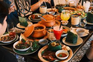 a table filled with plates of food and drinks at KuangSi Resort in Luang Prabang