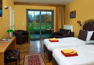 a hotel room with two beds and a balcony at Country Lodge Hotel Moriaanshoofd in Oudenaarde