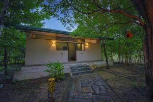 a small house with lights on the side of it at Tadoba Jungle Camp in Mohurli