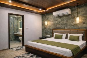 a bedroom with a large bed and a bathroom at Hotel PKD Vrindavan Near 100 Futta Main Road in Vrindāvan