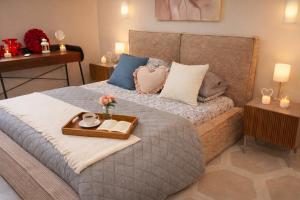 a bedroom with a bed with a tray on it at La Madonnella Home - locazione turistica in Adelfia +45 photos