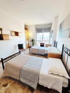 a hotel room with two beds and a window at Cà Letizia - ApArt Seregno centralissimo in Seregno