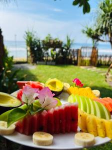 a plate of fruit and vegetables on a table at La Brisa By Harry Beach Villa in Dickwella