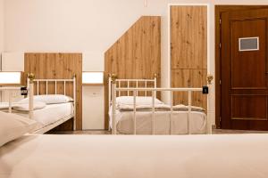 two beds in a room with wooden walls at Hostel Archi Rossi in Florence