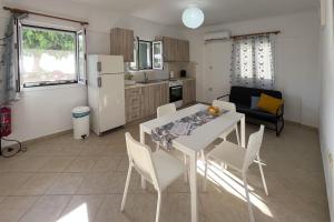 a kitchen and dining room with a table and chairs at Villa Evgenia in Yénion