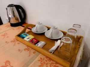a tray with a tea pot and glasses on a table at Chill Tangalle in Tangalle