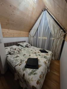 a bedroom with a bed with a comforter at Family House B in Witów