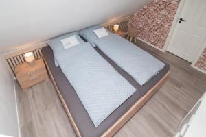 a rendering of a bed in a room at Leichte Brise 2 Greetsiel in Krummhörn