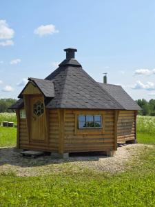 a log cabin with a black roof at Kilplaste küla kämpingud in Müüsleri