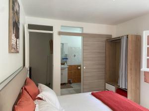 a bedroom with a bed and a sliding glass door at Mon petit coin de paradis in Morne-à-lʼEau +21 photos